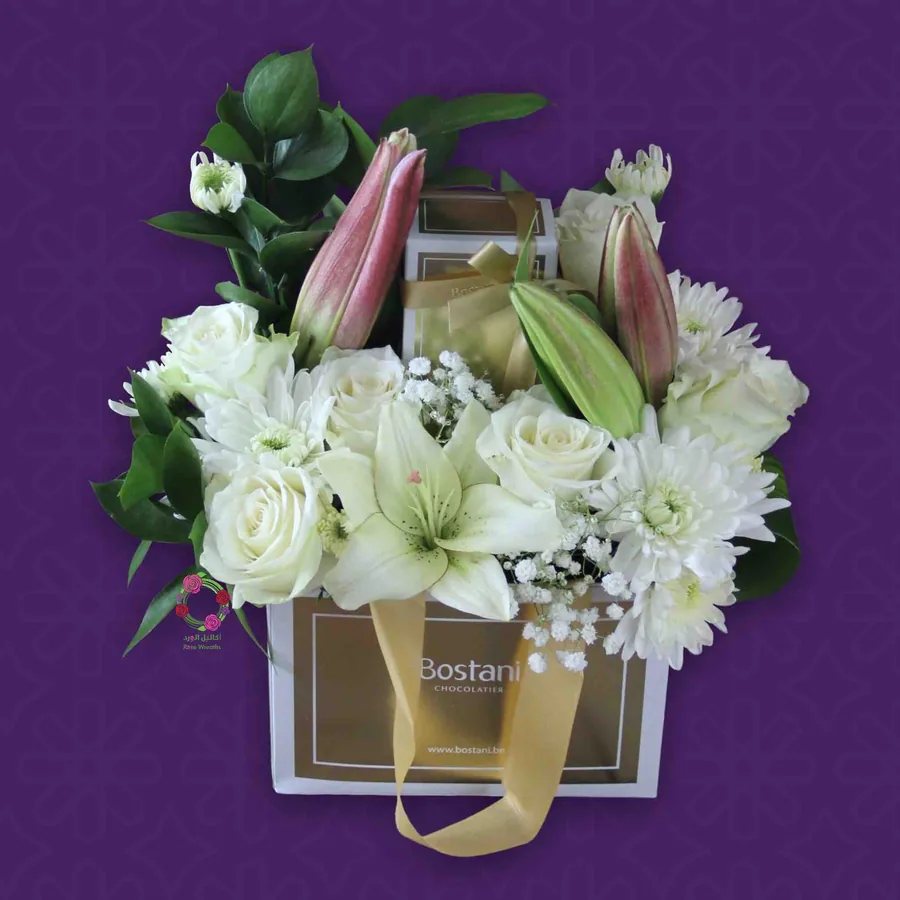 White lilies and roses with chocolates