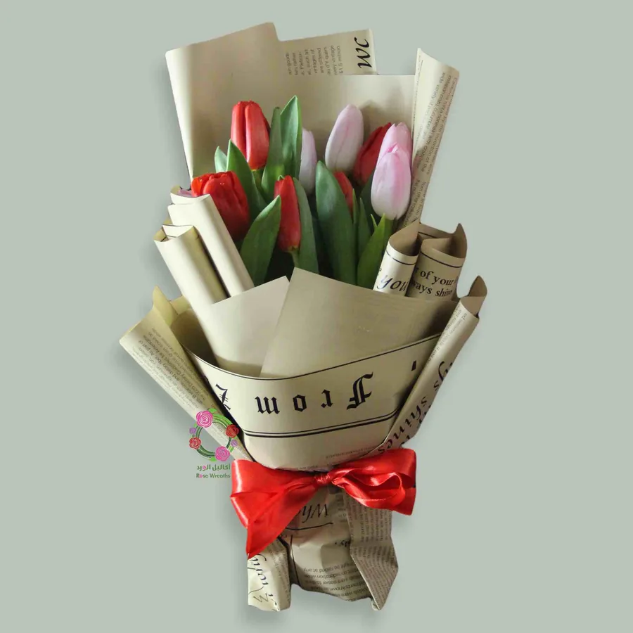 Tulips wrapped in kraft paper with a red bow